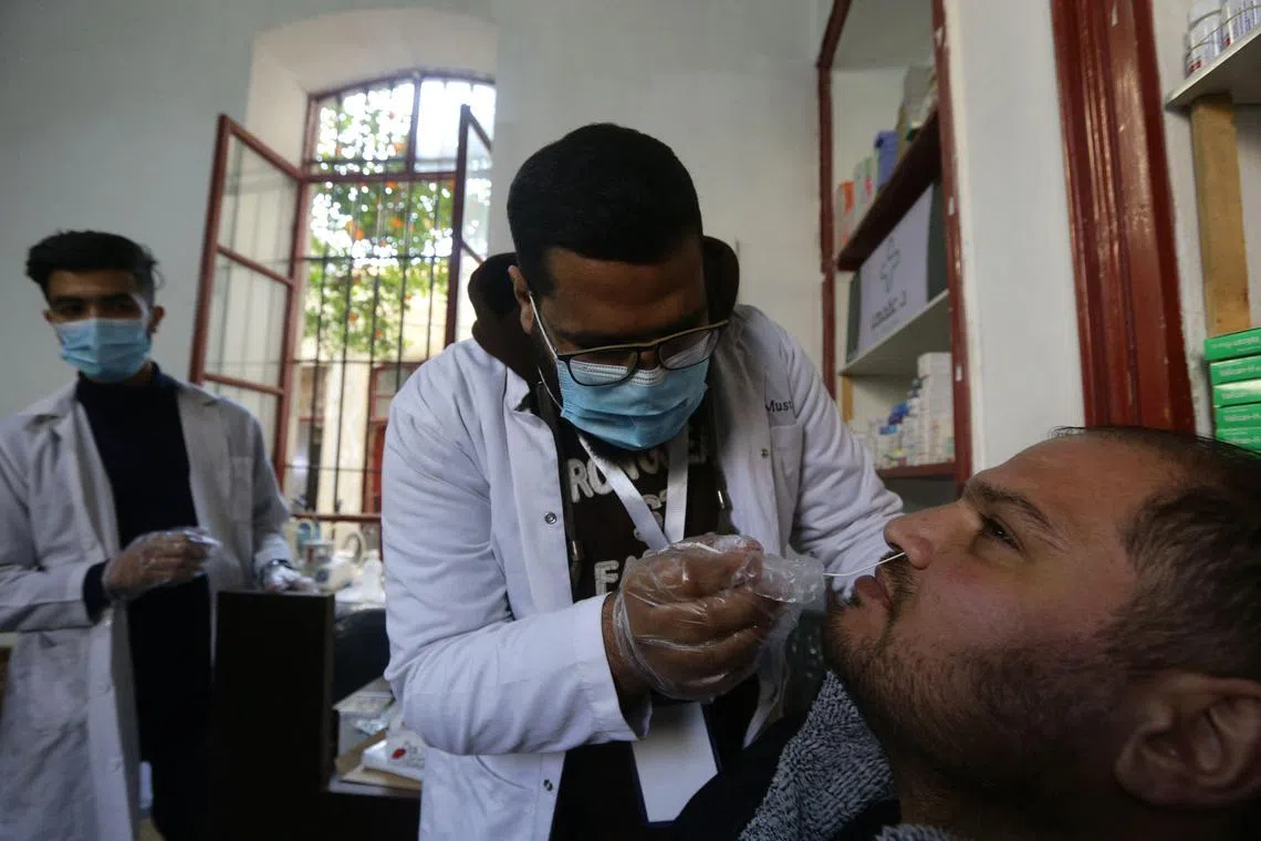 A patient is tested for Covid-19 at a medical centre in Damascus, Syria.