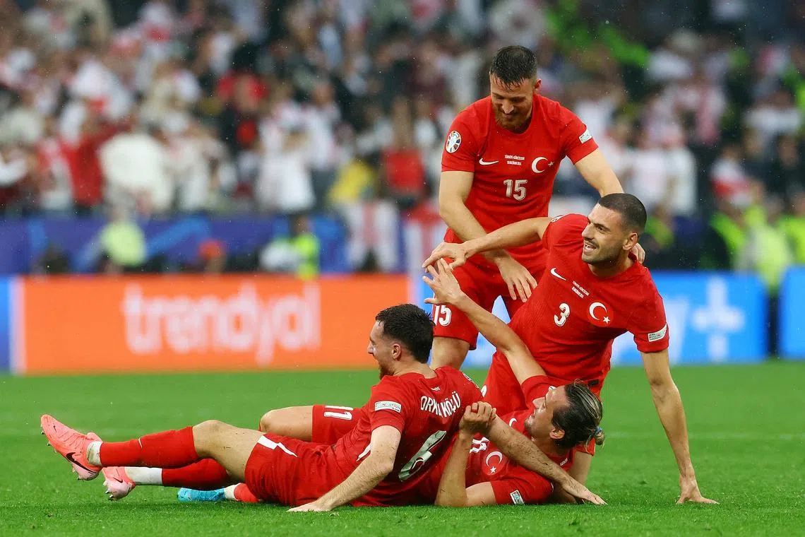 Soccer Football - Euro 2024 - Group F - Turkey v Georgia - Dortmund BVB Stadion, Dortmund, Germany - June 18, 2024 Turkey's Merih Demiral, Salih Ozcan, Yusuf Yazici and Orkun Kokcu celebrate after the match REUTERS/Bernadett Szabo