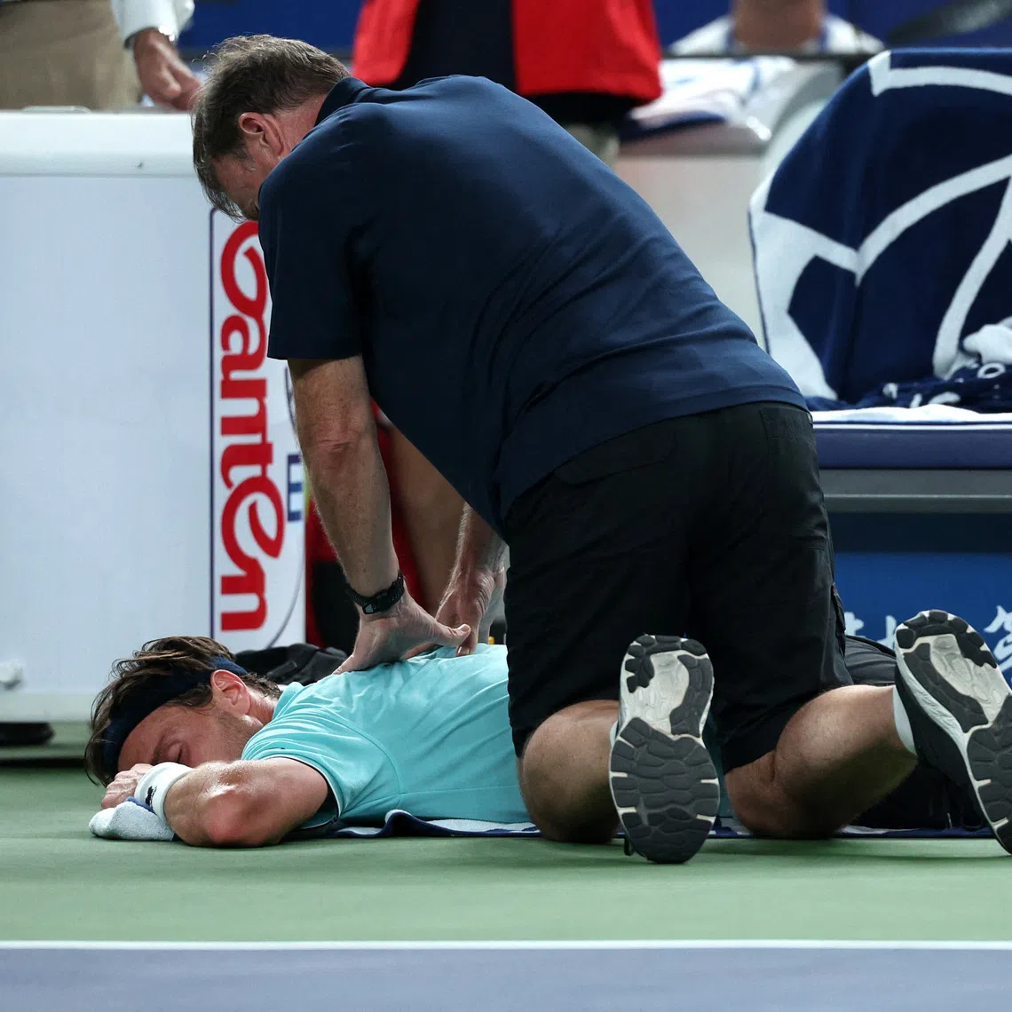 Tennis - ATP Masters 1000 - Shanghai Masters - Qizhong Forest Sports City Arena, Shanghai, China - October 12, 2025 France's Arthur Rinderknech receives medical attention during the final against Monaco's Valentin Vacherot REUTERS/Go Nakamura