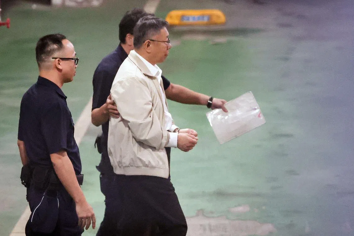 This picture taken and released by Taiwan’s Central News Agency (CNA) on September 5, 2024 shows ex-Taipei mayor and former presidential candidate Ko Wen-je being led to a police car to be taken to a detention centre in Taipei. Ko was detained on September 5 for alleged corruption after a Taiwanese court reversed a decision to release him, citing the risk of him destroying evidence and colluding with witnesses. (Photo by CNA / AFP) / China OUT - Taiwan OUT - Macau OUT / Hong Kong OUT RESTRICTED TO EDITORIAL USE