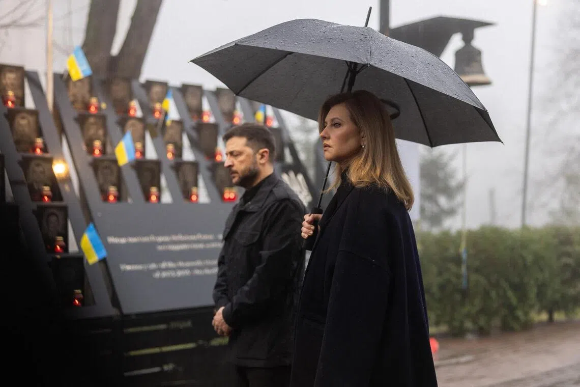 Ukrainian President Volodymyr Zelensky (left) and Ukrainian First Lady Olena Zelenska paying tribute on Nov 21 to demonstrators killed during freedom protests in Ukraine.