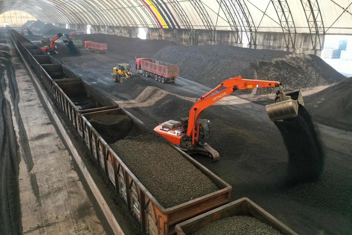 Coal unloaded from rail cars into a storage facility in China’s eastern Shandong province on Feb 21.