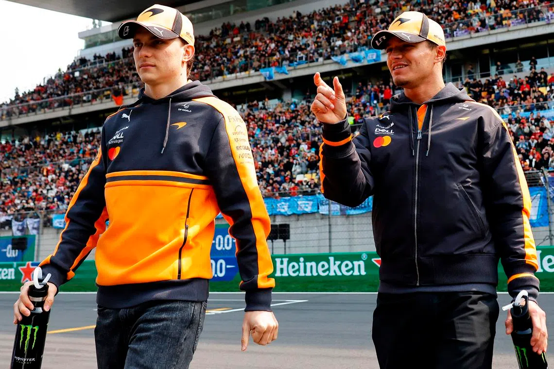 Formula One F1 - Chinese Grand Prix - Shanghai International Circuit, Shanghai, China - March 15, 2026 McLaren's Oscar Piastri and McLaren's Lando Norris during the drivers parade before the race REUTERS/Maxim Shemetov