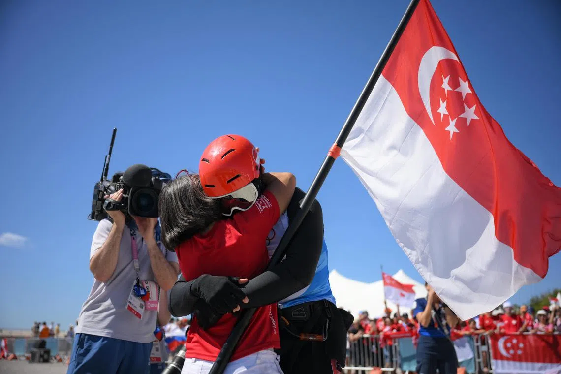 Singaporean Kitefoiler Maximilian Maeder hugs his mother after race 3of the Paris 2024 Olympics Men’s Kite final at the Marseille Marina on August 9, 2024.