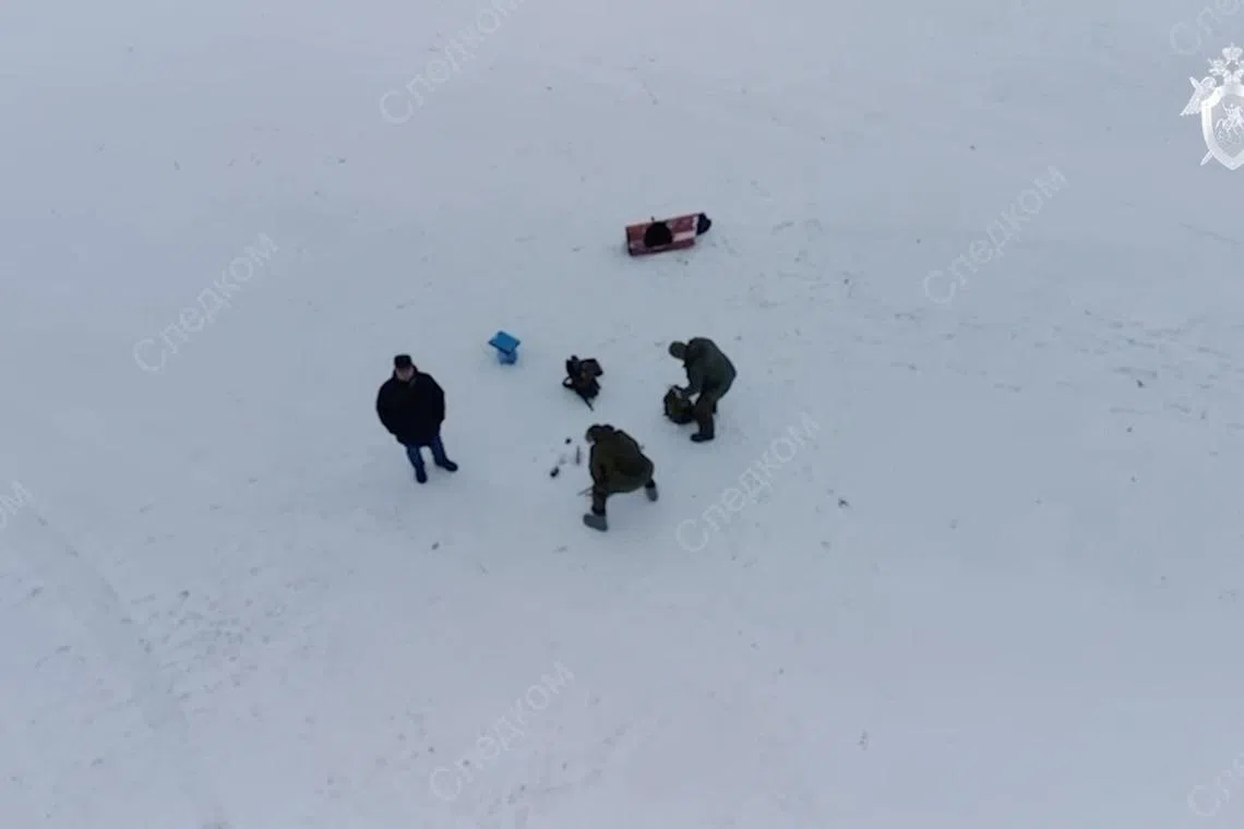 FILE PHOTO: Investigators examine what the Russian Investigative Committee says are fragments of missiles that were used to shoot down the Russian Ilyushin Il-76 military transport plane, at the crash site near the village of Yablonovo in the Belgorod region, Russia, in this still image from video released February 1, 2024. Russian Investigative Committee/Handout via REUTERS/File Photo