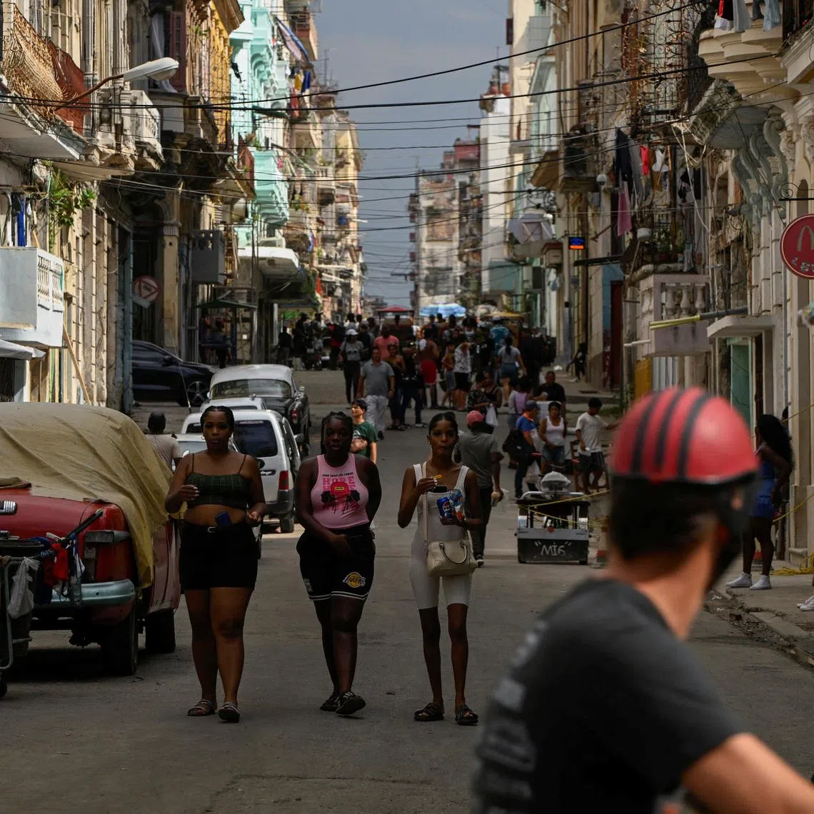 People walk on the street in downtown Havana, Cuba July 15, 2025. REUTERS/Norlys Perez