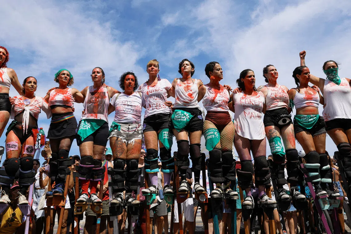 Women on stilts participating in a nationwide protest against femicide and gender-related violence, in Rio de Janeiro, Brazil, on Dec 7, 2025. 