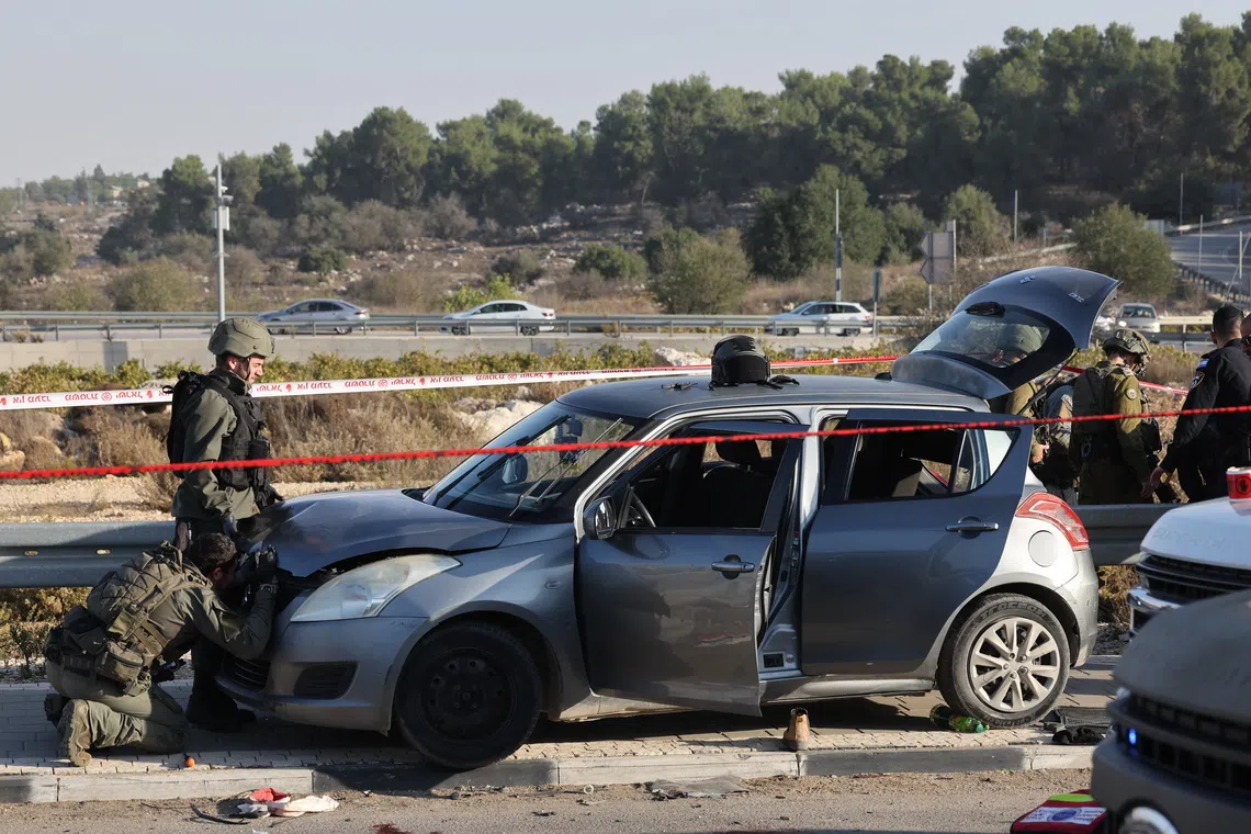 Israeli security forces inspecting a vehicle at the site of a reported ramming and stabbing attack in the area of Gush Etzion Junction in the West Bank on Nov 18.