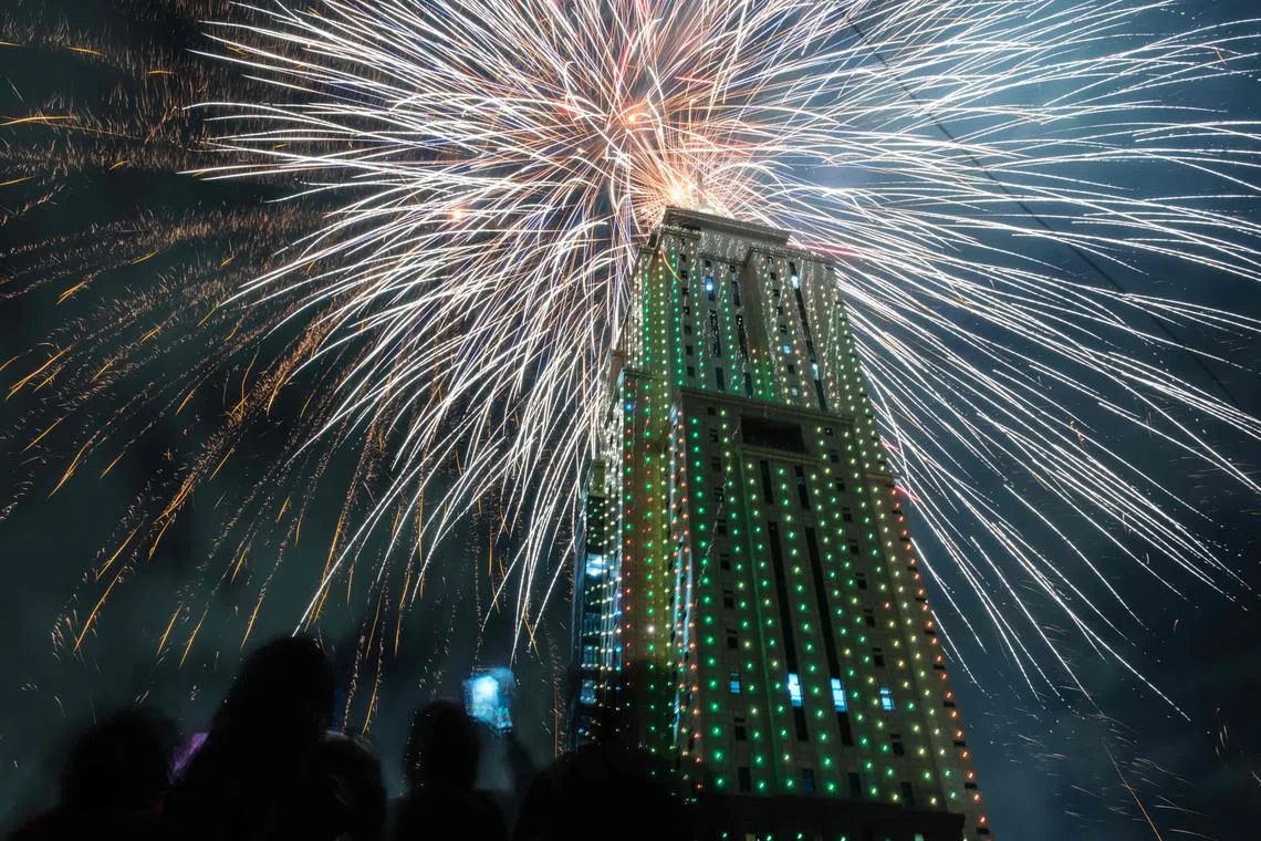 People look at fireworks launching from the building of Old Mutual Tower to celebrate the new year in Nairobi on Jan 1, 2023. 