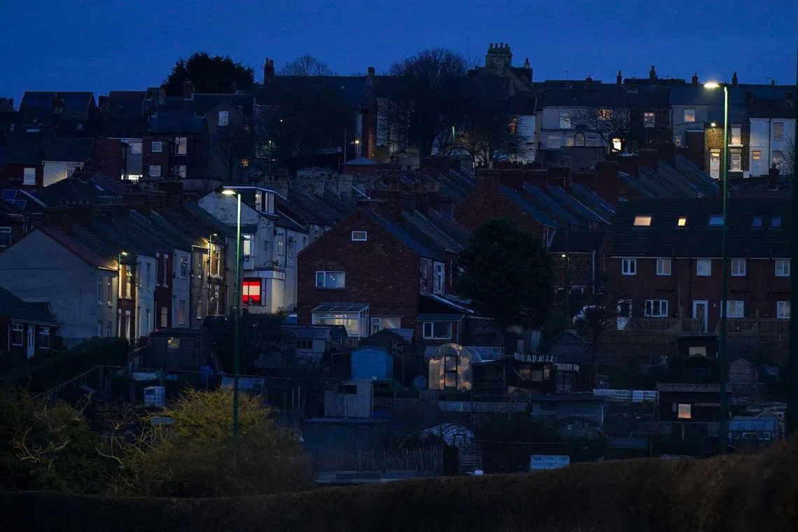 Lights on at residential houses before a period of peak energy demand in Brotton, UK, on Jan 23, 2023. 