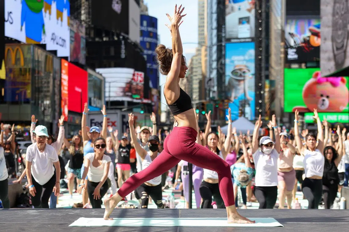 Yoga teacher Cealia Brannan, teaching a free yoga class to celebrate the Summer Solstice, called 'Solstice in Times Square: Mind Over Madness Yoga', at Times Square in New York, New York, USA, on June 20, 2024.  