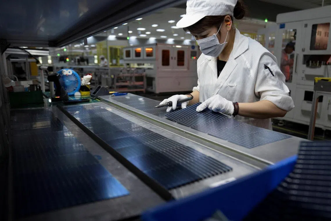 FILE PHOTO: An employee works on the production line for solar panels at a factory of GCL System Integration Technology in Hefei, Anhui province, China May 16, 2024.  China Daily via REUTERS ATTENTION EDITORS - THIS PICTURE WAS PROVIDED BY A THIRD PARTY. CHINA OUT. NO COMMERCIAL OR EDITORIAL SALES IN CHINA./File Photo