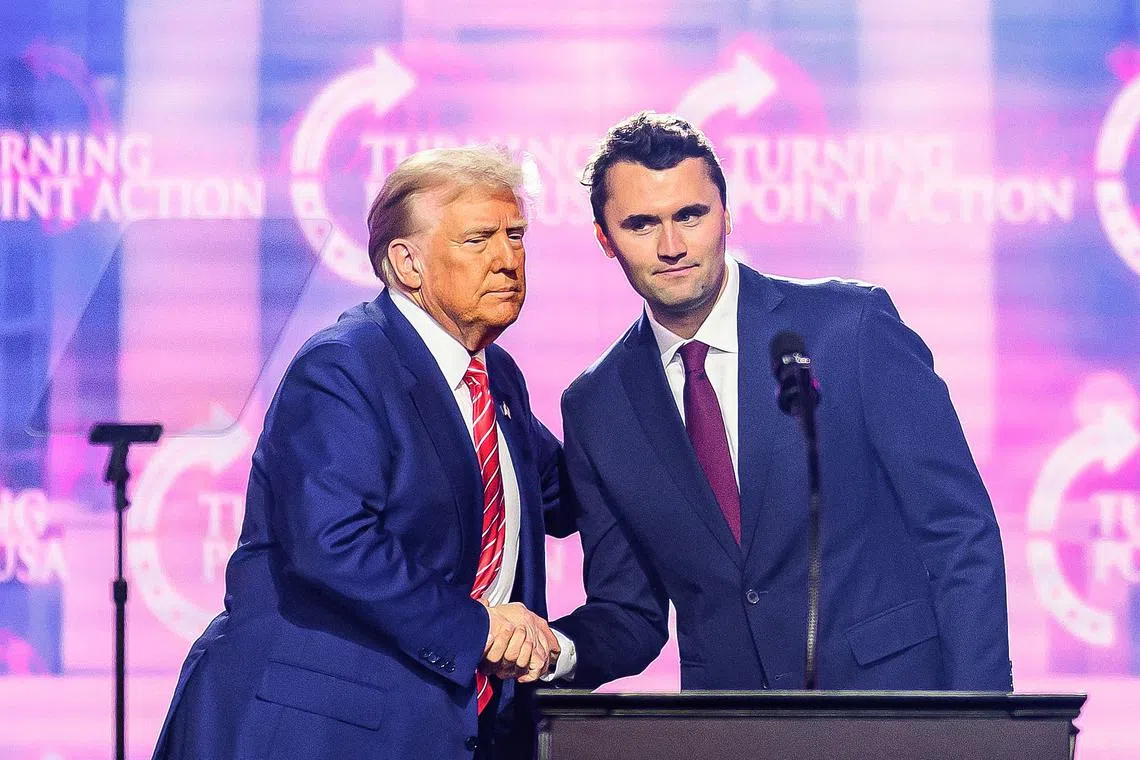Right-wing activist Charlie Kirk (right) on stage with President Donald Trump at America Fest 2024 in Phoenix, Arizona, on Dec 22, 2024.