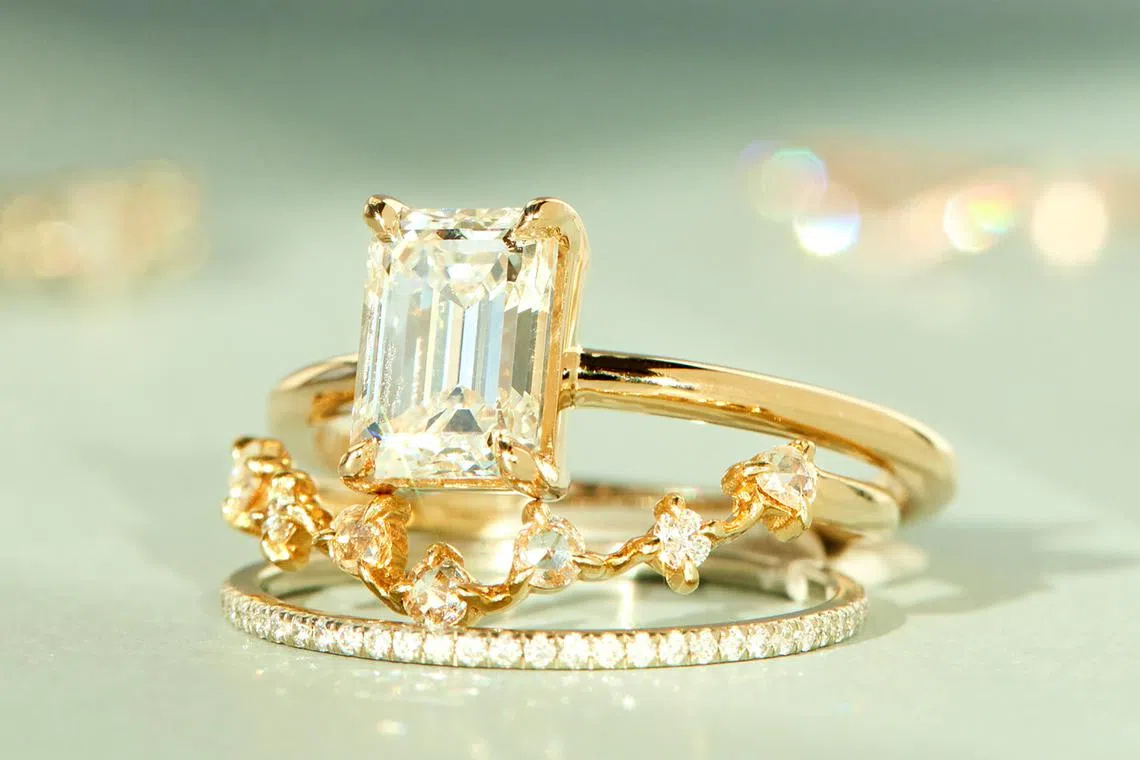In an undated image provided by Catbird, lab-grown diamonds in Catbird's gold engagement ring and wedding bands. Lab-grown diamonds are created using machines that mimic the pressure needed to create a natural stone. 