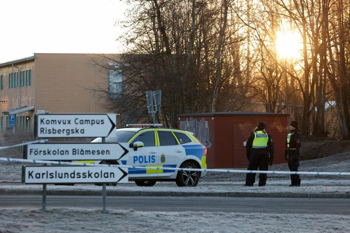 Police officers stand near the Risbergska school, following a deadly shooting attack at the adult education centre, in Orebro, Sweden, February 7, 2025. REUTERS/Kuba Stezycki
