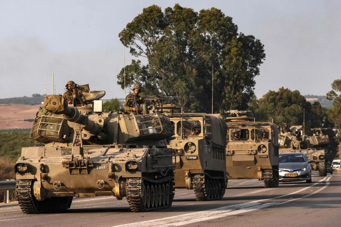 An Israeli self-propelled howitzer rolls on a highway near the southern city of Sderot.