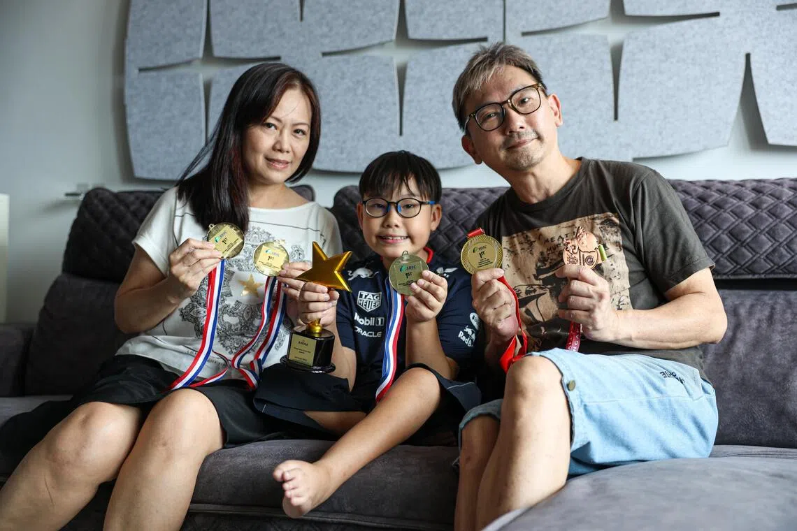 Primary 5 pupil Bryan Lee, who lives with spinal muscular atrophy, with his parents and his para swimming medals.
