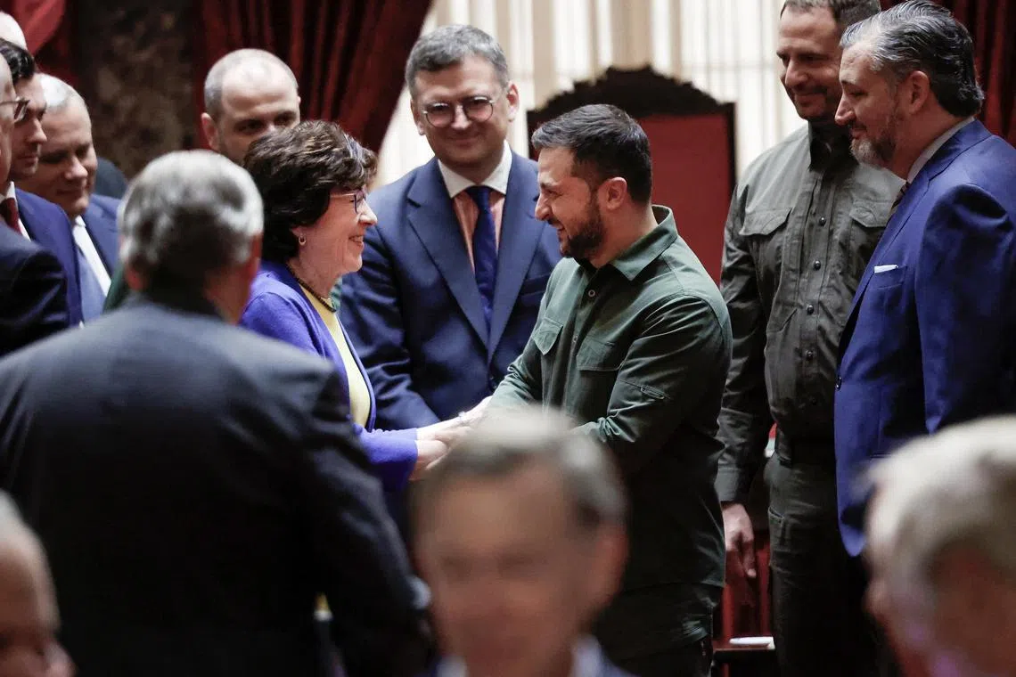 Ukrainian President Volodymyr Zelensky (centre), flanked by members of his delegation, is greeted by US Senators Susan Collins, Ted Cruz and others, after a meeting with members of the US Senate in Washington.