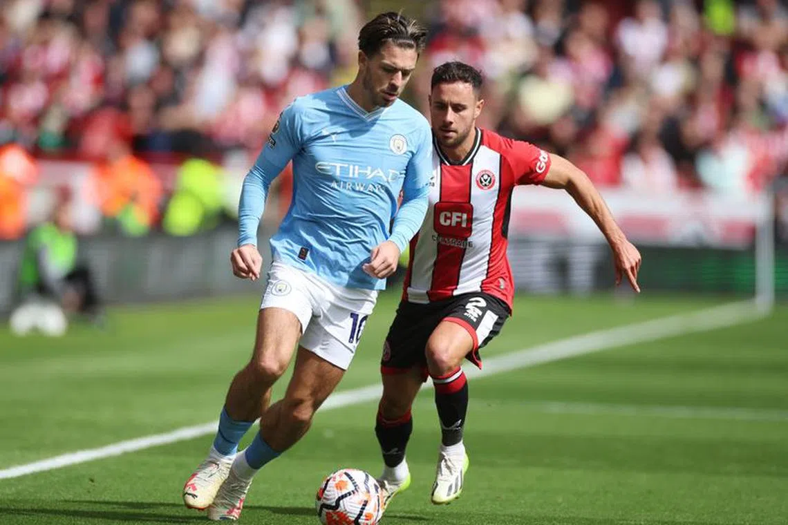 Soccer Football - Premier League - Sheffield United v Manchester City - Bramall Lane, Sheffield, Britain - August 27, 2023 Manchester City's Jack Grealish in action with Sheffield United's George Baldock REUTERS/Phil Noble/File photo