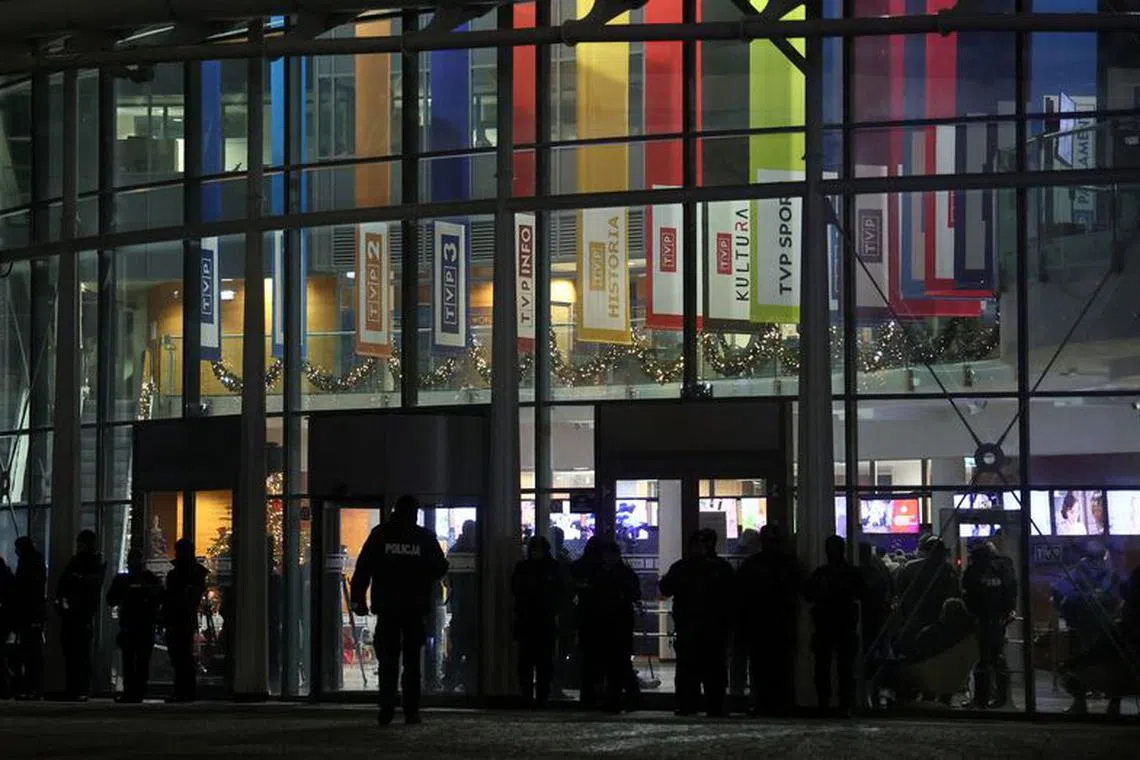 Police stand outside the Polish public television TVP building as protesters and Law and Justice politicians gather after Poland's new government took a public news channel off the air and dismissed executives from state media to restore \"impartiality,\" the culture ministry said, in Warsaw, Poland, December 20, 2023. REUTERS/Kacper Pempel/ File Photo