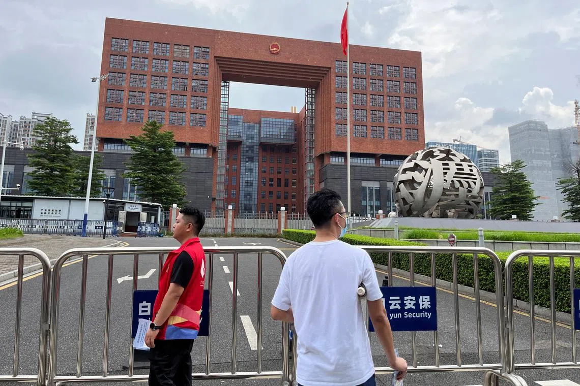 People stand outside Guangzhou Intermediate People's Court, where #MeToo activist Huang Xueqin and labour activist Wang Jianbing are expected to be sentenced, in Guangzhou, Guangdong province, China June 14, 2024. REUTERS/David Kirton