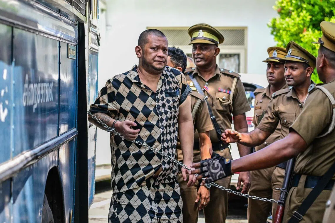 Prison guards escorting a foreign national in Kaduwela, a suburb of Colombo, in Sri Lanka, on May 7.