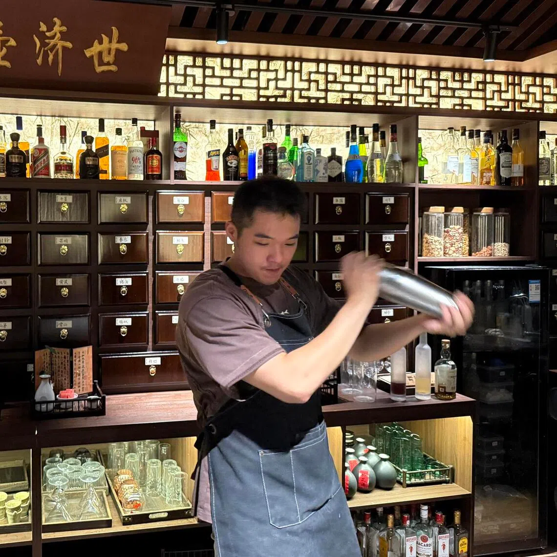 jytcm - A bartender shakes up a herbal cocktail at Niang Qing, a TCM-themed bar in Shanghai.

ST PHOTO: JOYCE ZK LIM