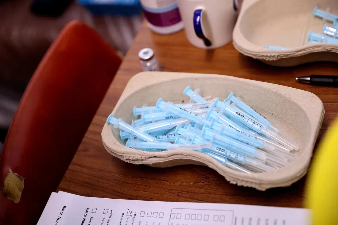 FILE PHOTO: Syringes with doses of the COVID-19 booster vaccine are seen amid the coronavirus disease (COVID-19) pandemic, at Smallthorne Community Centre in Stoke-on-Trent, Britain, December 15, 2021. REUTERS/Carl Recine/File Photo