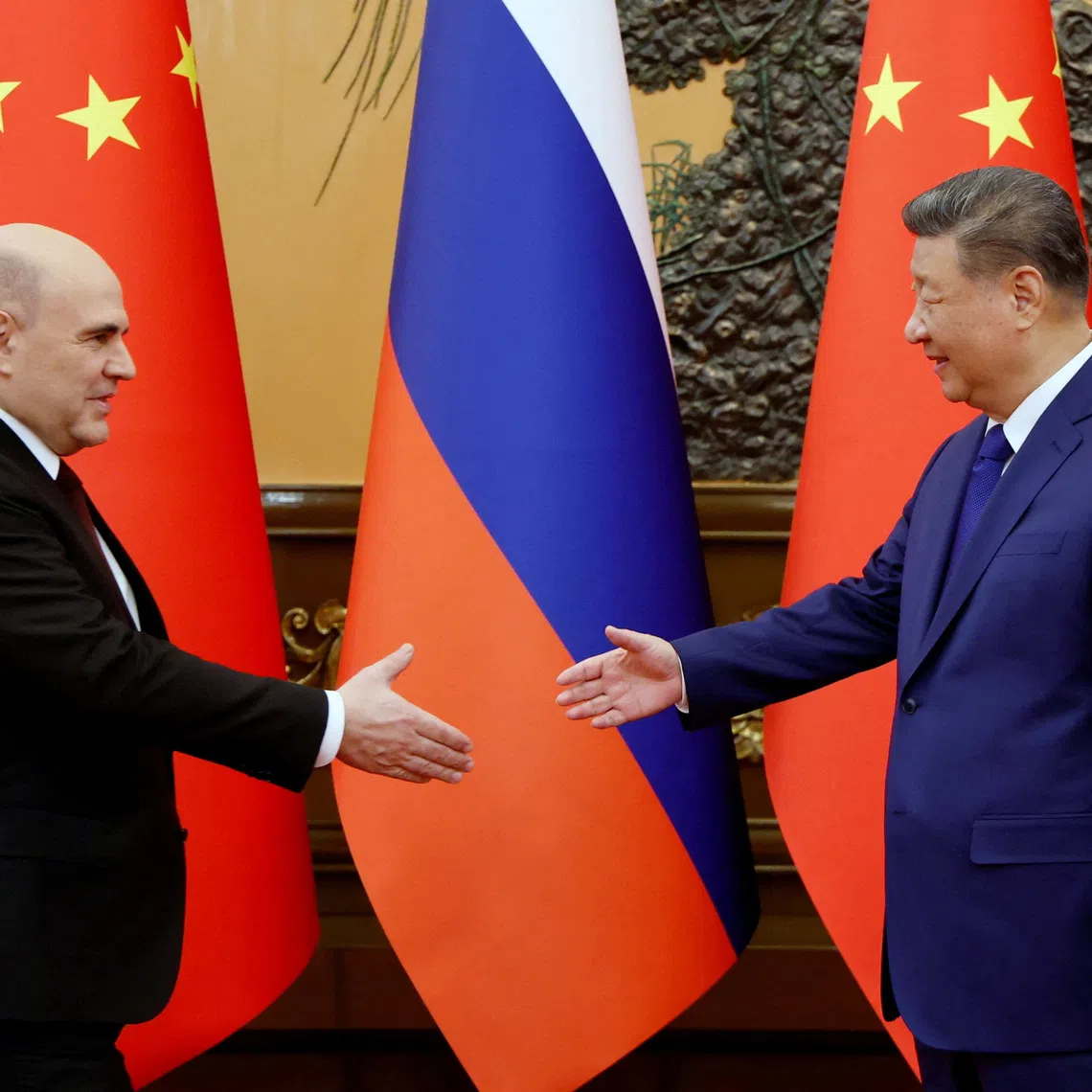 Russian Prime Minister Mikhail Mishustin shakes hands with Chinese President Xi Jinping during a meeting at the Great Hall of the People in Beijing, China, November 4, 2025. Sputnik/Dmitry Astakhov/Pool via REUTERS