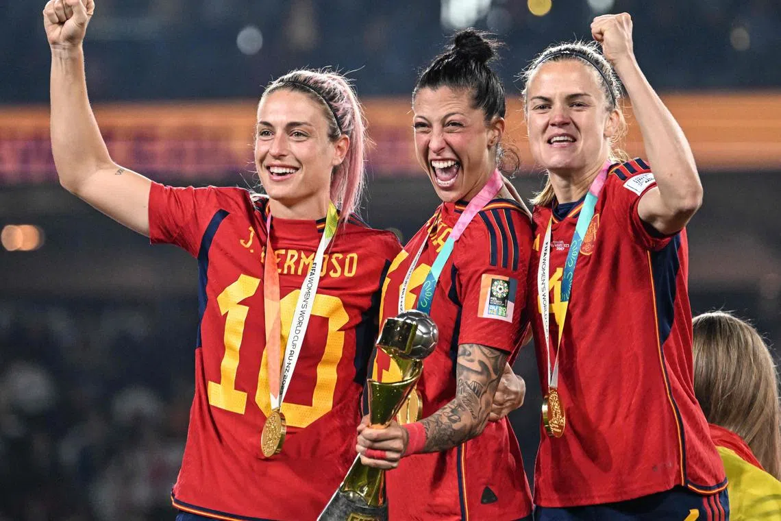 Spain players celebrating with the trophy after beating England 1-0 to win the Women's World Cup at Stadium Australia in Sydney on Sunday.