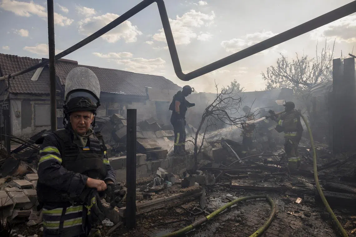 Emergency workers putting out the blaze after a Russian strike on a residential area destroyed a house in Pokrovsk, Ukraine.