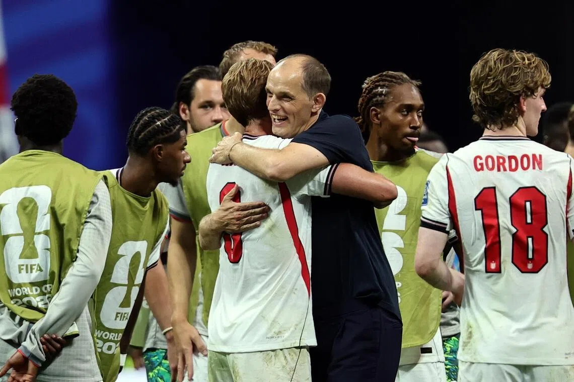 England coach Thomas Tuchel (in black) hugging goal scorer Harry Kane on July 1.