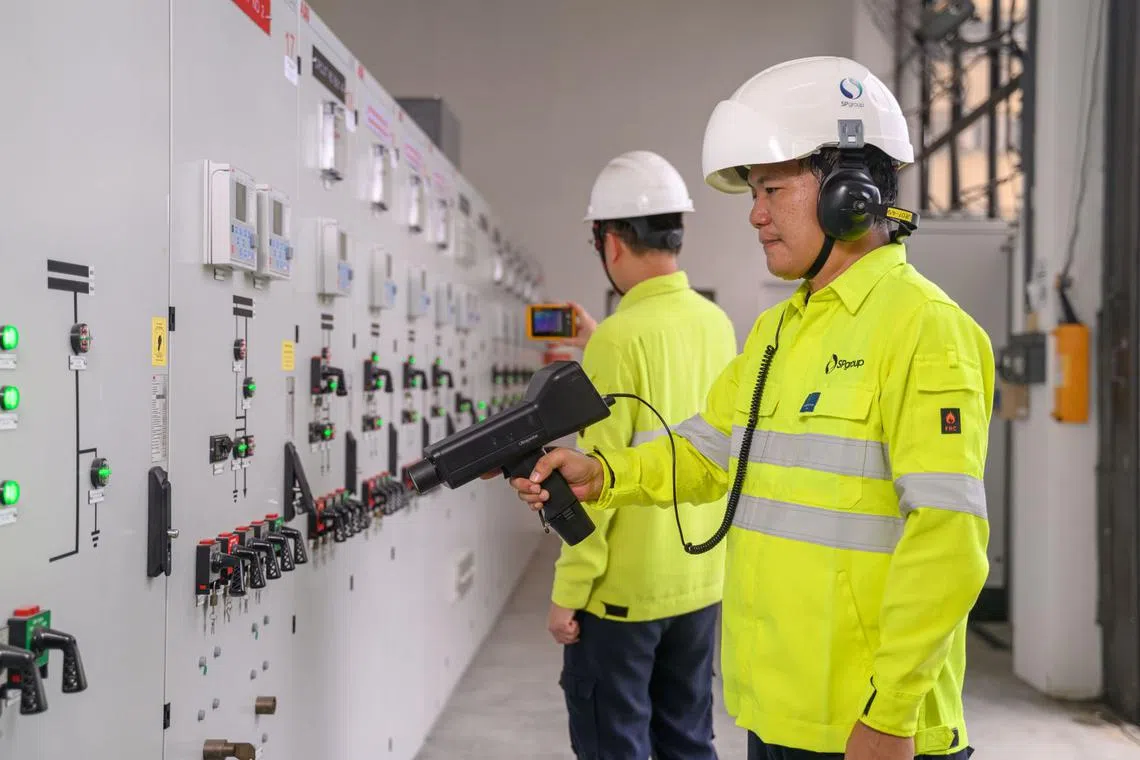 Mr Eric Lee (front) and his colleagues use smart sensors to detect anomalies in the electrical equipment in substations.