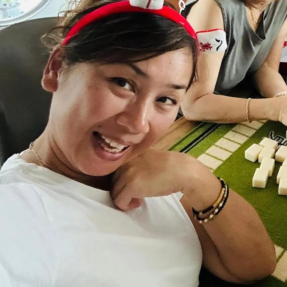 Singaporean actress Vernetta Lopez (right) plays mahjong with her mother, Doreen (centre) and older sister  Loretta (left).