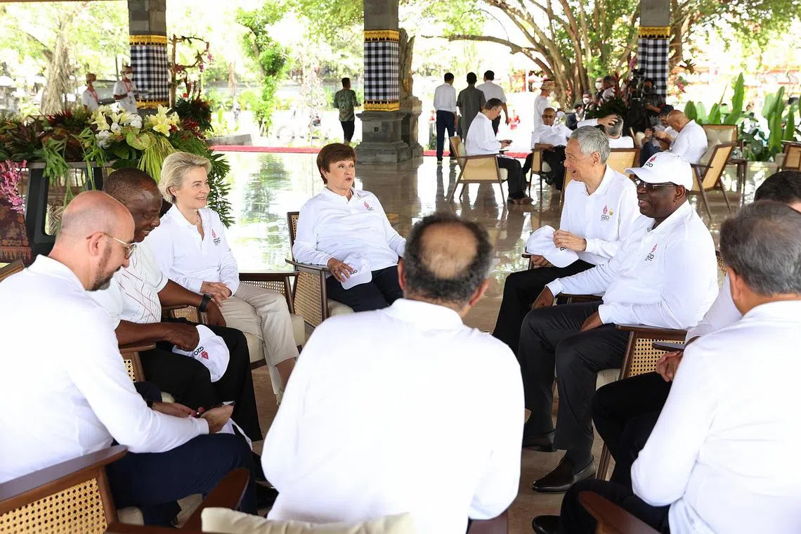 Prime Minister Lee Hsien Loong (thrid from right) speaking with other delegates during a visit to a mangrove forest in Bali during the G-20 Leaders' Summit, on Nov 16, 2022. 