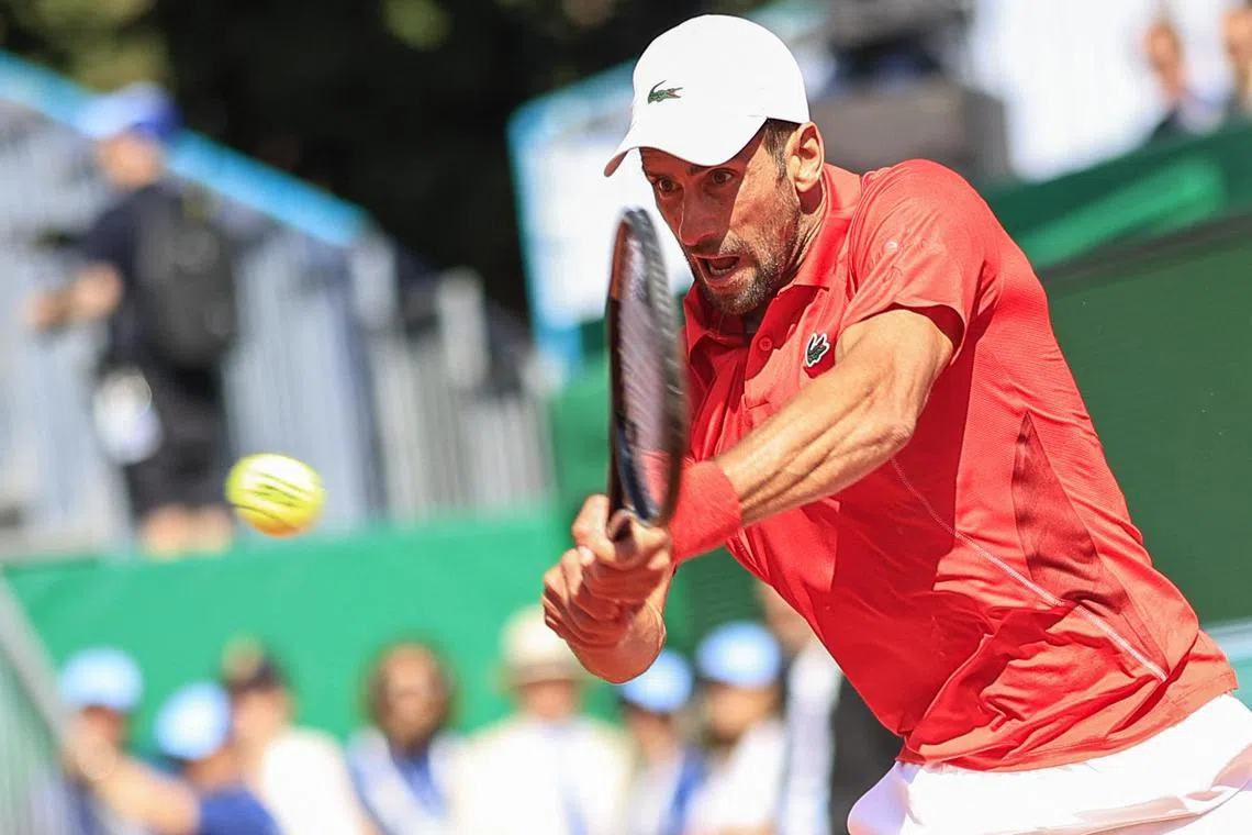Serbia's Novak Djokovic plays a backhand return to Italy's Lorenzo Musetti.