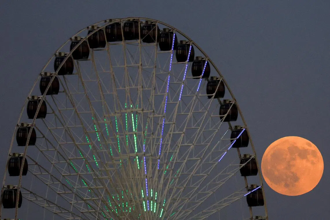 The blood moon rises in the sky during a total lunar eclipse, in Baghdad, Iraq, on Sept 7, 2025. 