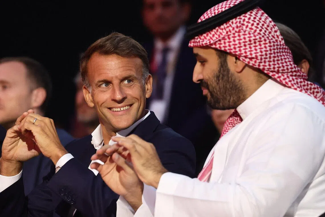 French President Emmanuel Macron (left) and the Crown Prince and Prime Minister of Saudi Arabia Mohammed bin Salman attend the closing ceremony of the Esports World Cup at the Grand Palais in Paris, France, on Aug 23.