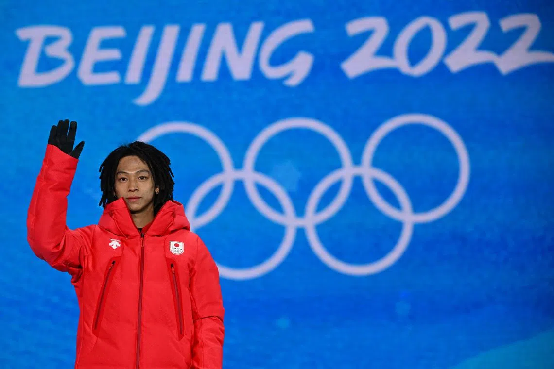 FILE PHOTO: 2022 Beijing Olympics - Victory Ceremony - Snowboard - Men's Snowboard Halfpipe - Zhangjiakou Medals Plaza, Zhangjiakou, China - February 11, 2022. Gold medallist, Ayumu Hirano of Japan celebrates on the podium. REUTERS/Dylan Martinez/File Photo