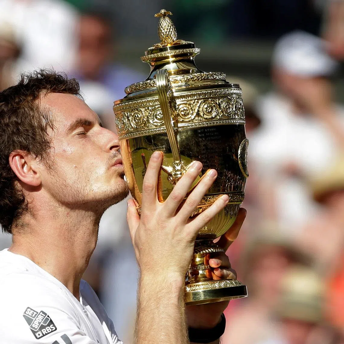FILE PHOTO: Andy Murray of Britain kisses the winners trophy after defeating Novak Djokovic of Serbia (R) in their men's singles final tennis match at the Wimbledon Tennis Championships, in London July 7, 2013. REUTERS/Anja Niedringhaus/Pool/File Photo