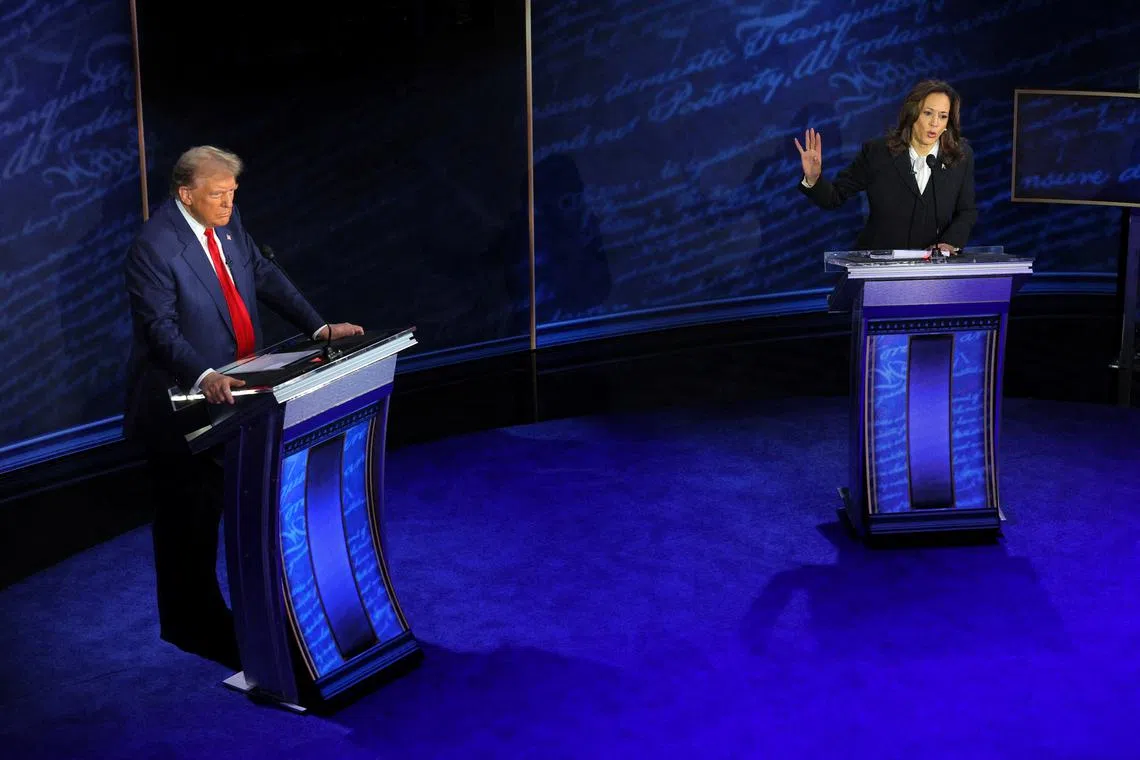 Democratic presidential nominee, U.S. Vice President Kamala Harris speaks during a presidential debate hosted by ABC as Republican presidential nominee, former U.S. President Donald Trump listens, in Philadelphia, Pennsylvania, U.S., September 10, 2024. REUTERS/Brian Snyder TPX IMAGES OF THE DAY