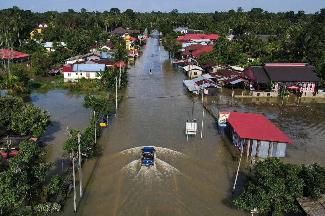 An aerial view shows houses surrounded by floodwaters after heavy rain in Tumpat, Malaysia's Kelantan state on Dec 2, 2024.