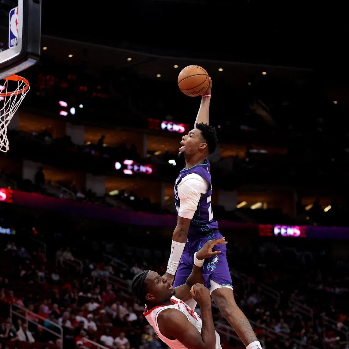 Charlotte Hornets forward Brandon Miller attempts to dunk against Houston Rockets center Clint Capela during the first quarter at Toyota Center. 