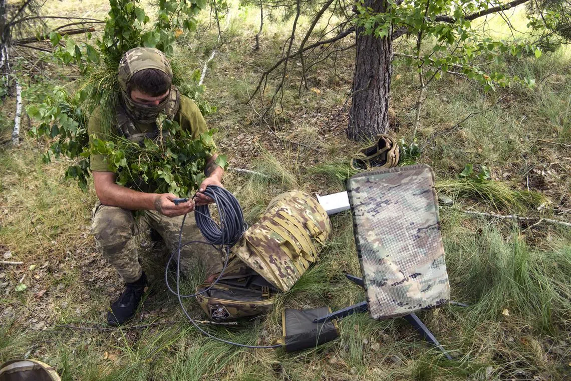 A Ukrainian soldier using the Starlink system during military exercises in Ukraine's  Chernihiv region in 2023.