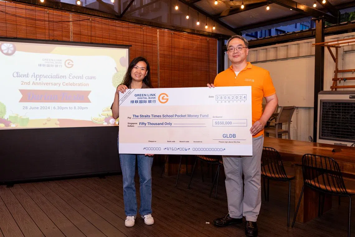 Green Link Digital Bank chief executive officer Melvin Teo (right) presenting a mock cheque to STSPMF general manager Lau Hui Ling on June 28.