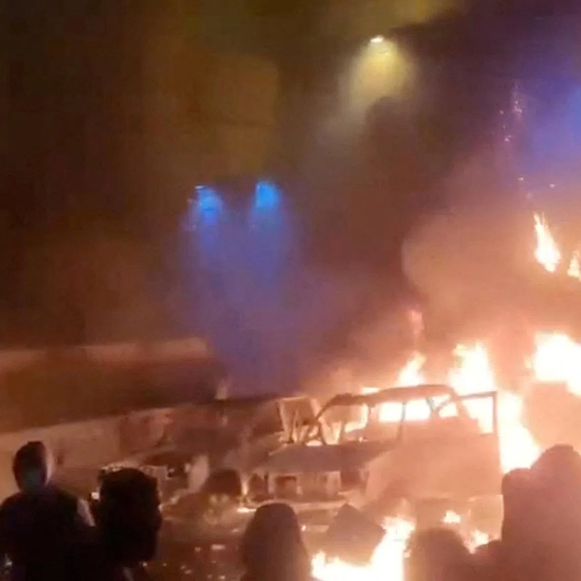 Protesters gather as vehicles burn, amid evolving anti-government unrest, in Tehran, Iran, in this screen grab obtained from a social media video released on January 9, 2026. Social Media/via REUTERS