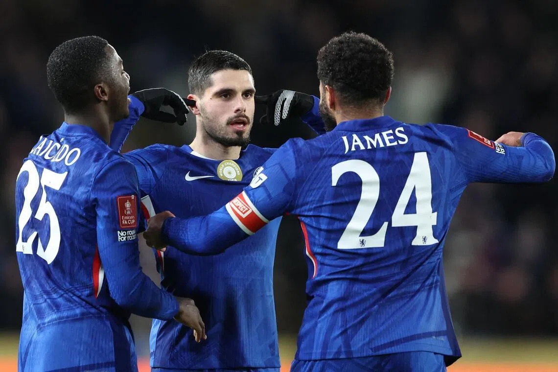 Chelsea's Pedro Neto celebrates scoring their first goal with Moises Caicedo and Reece James.