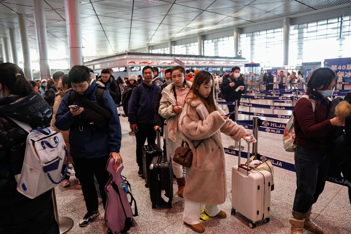 People wait in line to go through the security check at an airport in Harbin, Heilongjiang province, China January 8, 2024. REUTERS/Tingshu Wang/File Photo
