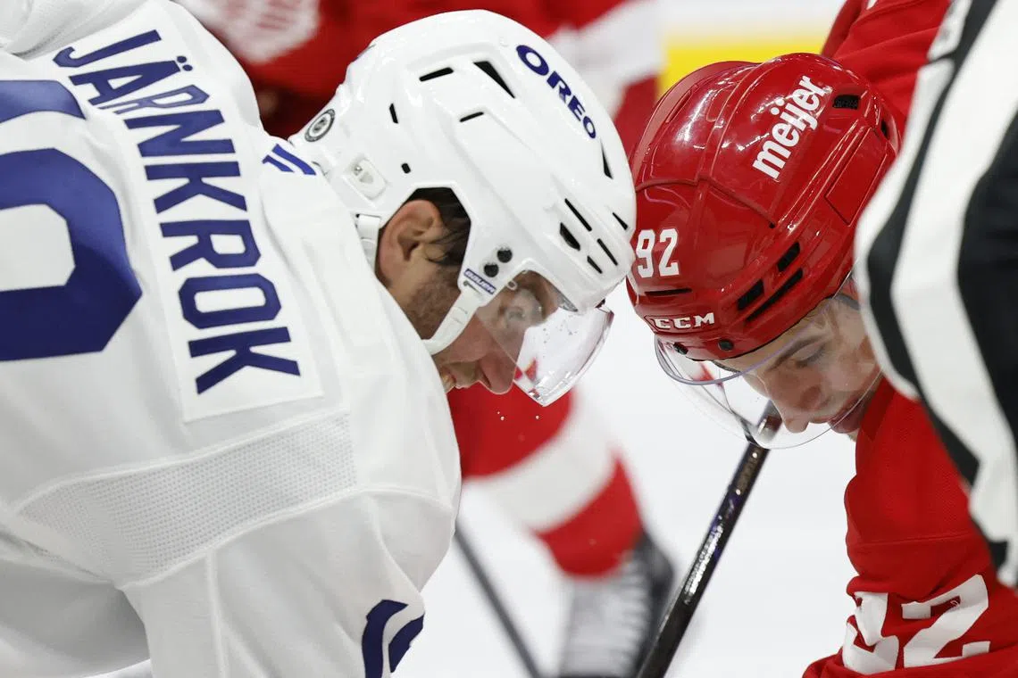 Oct 3, 2024; Detroit, Michigan, USA; Detroit Red Wings center Marco Kasper (92) and Toronto Maple Leafs center Calle Jarnkrok (19) face off in the second period at Little Caesars Arena. Mandatory Credit: Rick Osentoski-Imagn Images