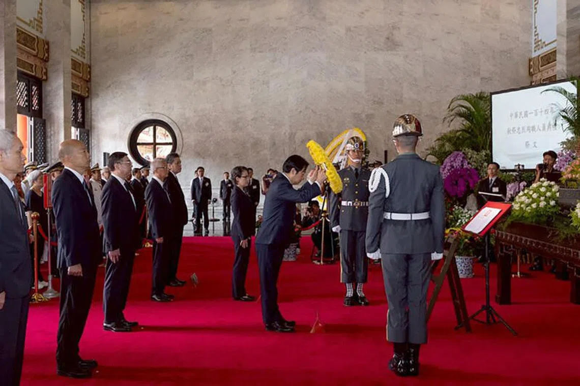 Taiwanese President Lai Ching-te laying flowers at the memorial tablets of the martyrs of the National Revolution.